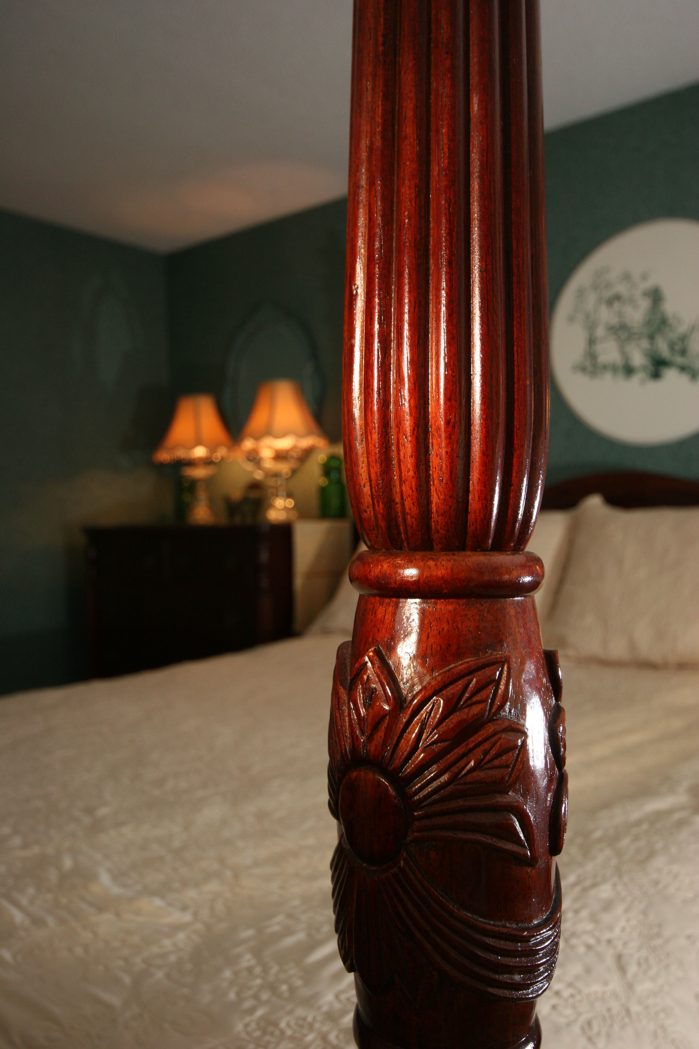 A closeup photo of a post from the 4-poster bed. Lovely wood carving.