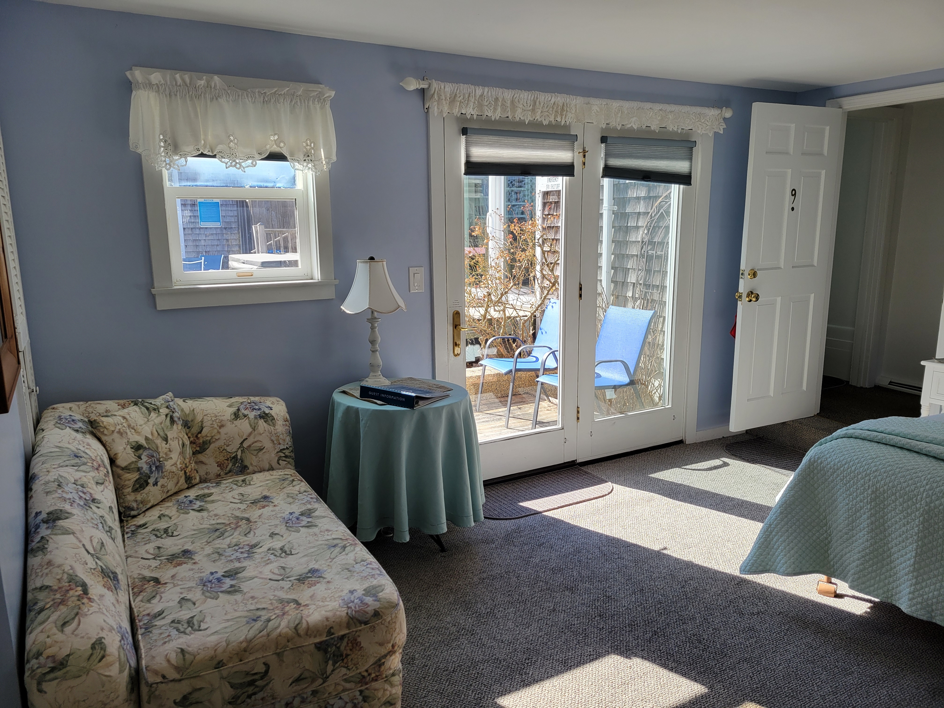 A photo of Sweet p with a light blue bed comforter and flowery love seat