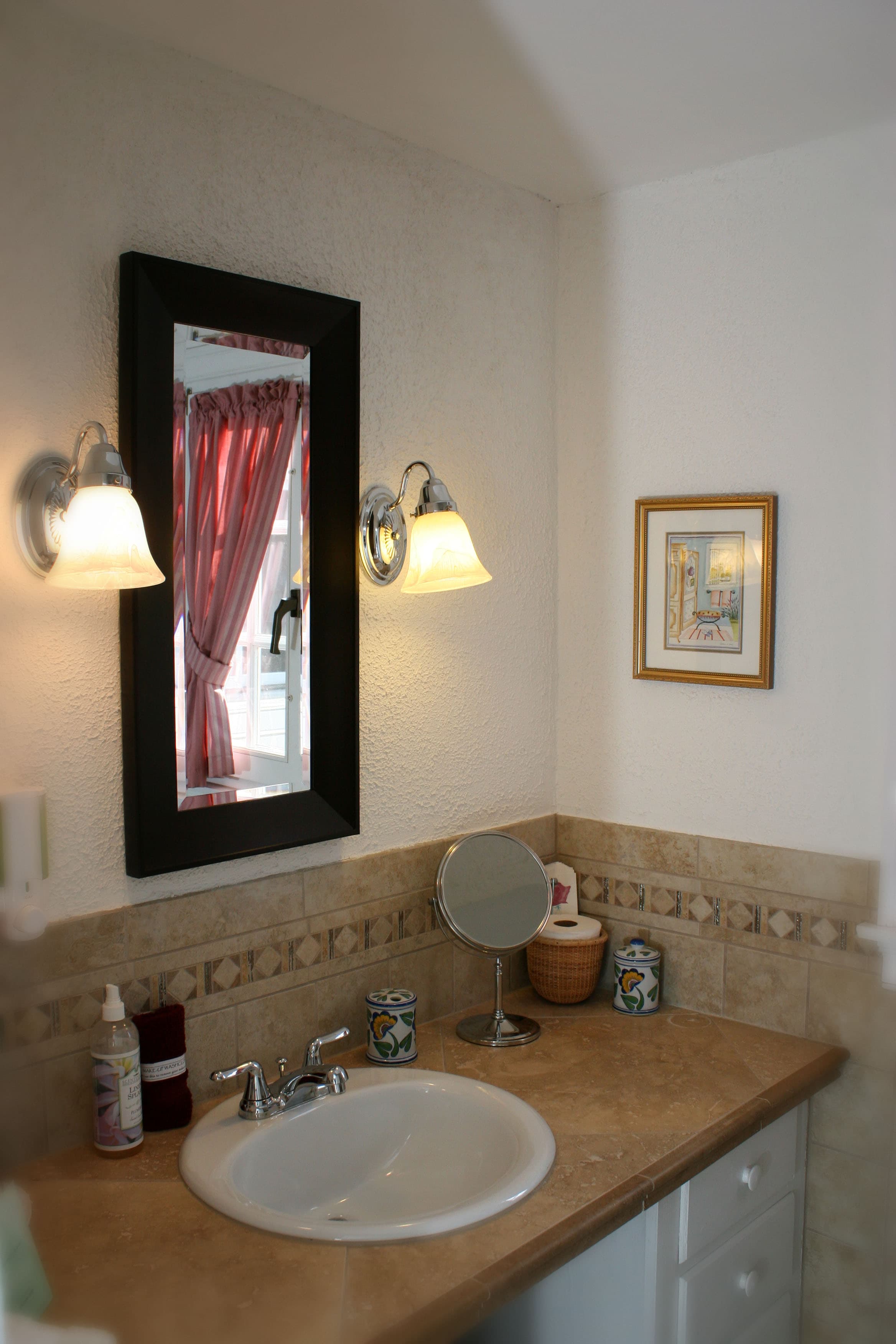 Photo of Sweet 9 bathroom sink with stone work and brown tiling