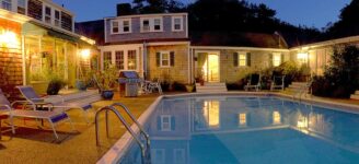 Night time photo of the inn's courtyard, pool and fireplace